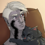 Szelek sitting in a chair with Fel snuggling him